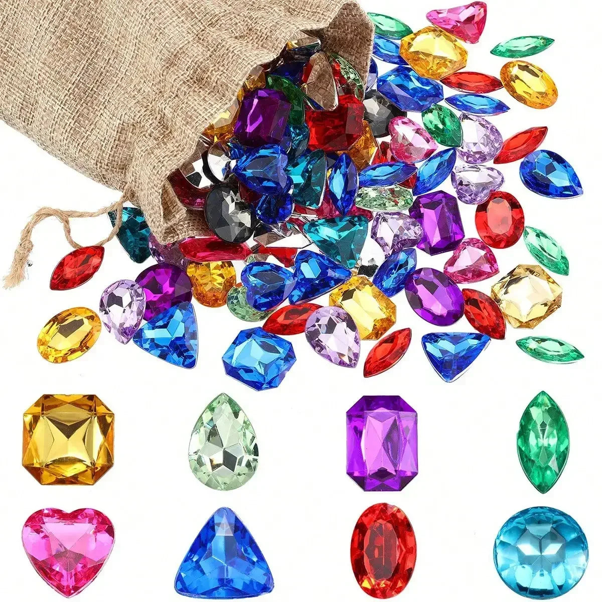 A collection of colorful acrylic gemstones including rubies, sapphires, emeralds, and citrine scattered on a burlap fabric.