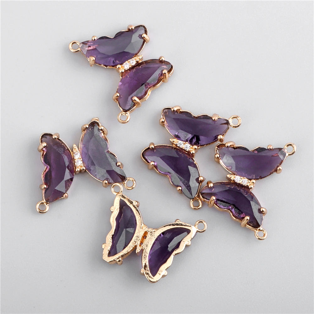 A set of purple crystal butterfly charm beads used for jewelry making.