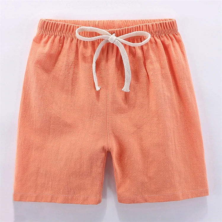 Peach colored linen shorts for kids with an adjustable drawstring waist