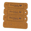A set of three brown leather-style handmade tags with a heart design for crafts and sewing.
