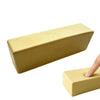 A rectangular, pale yellow squishy butter stick fidget toy being held by a hand.