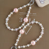 A delicate pearl crystal necklace featuring pink and clear stones with a star charm and bag clip.