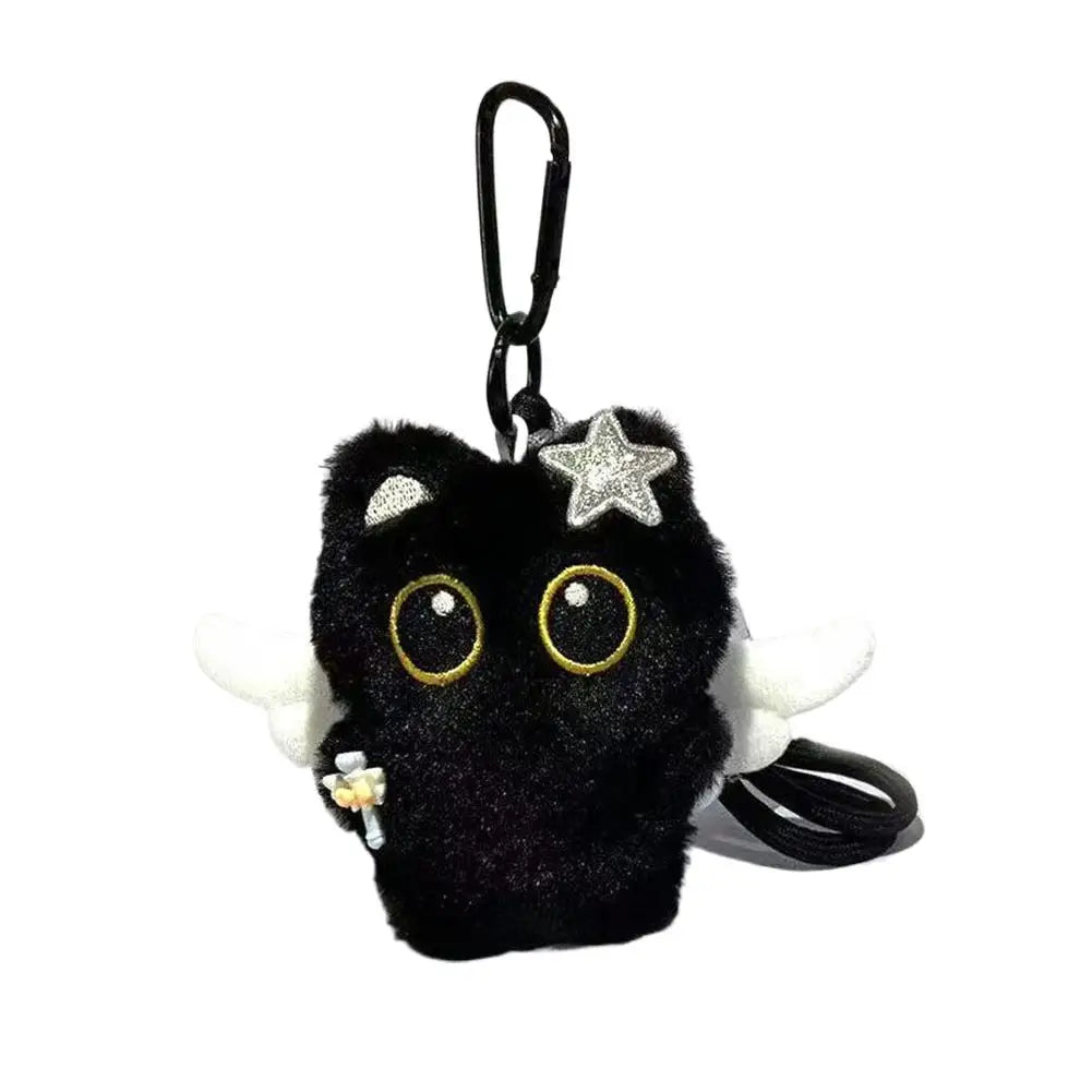A cute plush black cat keychain with gold eyes and a silver star charm.
