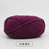 A ball of deep magenta pre-dyed milk cotton yarn used for knitting and crochet.