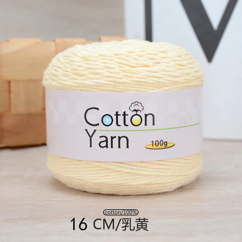 A ball of light yellow cotton yarn labeled Cotton Yarn 100g with a measurement of 16 CM.