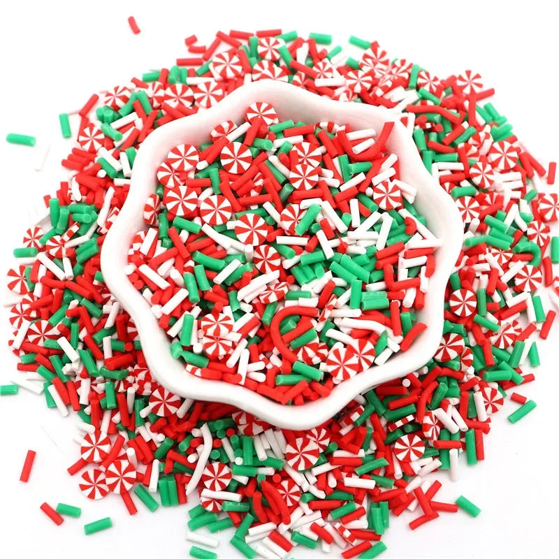 A pile of red, green, and white polymer clay sprinkles mix for slime decor and DIY craft accents.