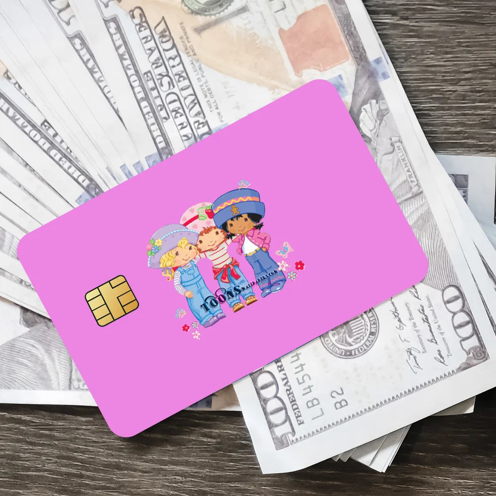 A pink card featuring cute illustrations of a strawberry and shortcake character on a background of US currency.