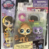 A set of three mini posable animal figures, including a brown monkey, a purple cat, and a yellow tiger, packaged in clear pla