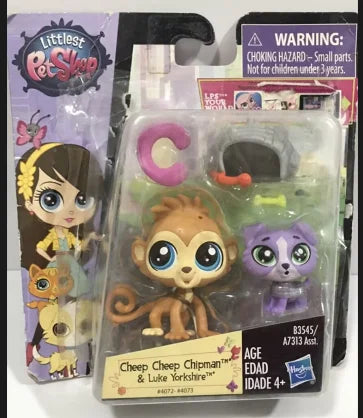 A set of three mini posable animal figures, including a brown monkey, a purple cat, and a yellow tiger, packaged in clear pla