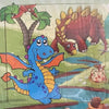 A 20-piece wooden puzzle featuring dinosaurs and jungle animals, including a blue dinosaur and a large reddish dinosaur.