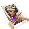 A hand is painting a portrait of an African woman with a diamond painting kit on a canvas.