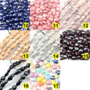 A collection of various heart-shaped acrylic beads in shades of blue, pink, and brown for jewelry making.
