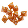 A set of ten translucent amber acrylic polyhedral dice showing various numbers and shapes.