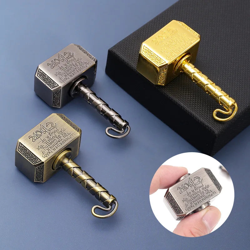 A set of brass and silver hammer-shaped metal fidget spinners with transformable designs displayed on a dark surface.