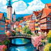 A colorful painting depicts a historic European town with half-timbered houses and a bridge over a blue river.