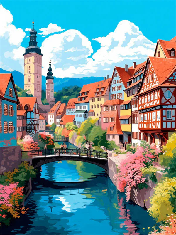 A colorful painting depicts a historic European town with half-timbered houses and a bridge over a blue river.