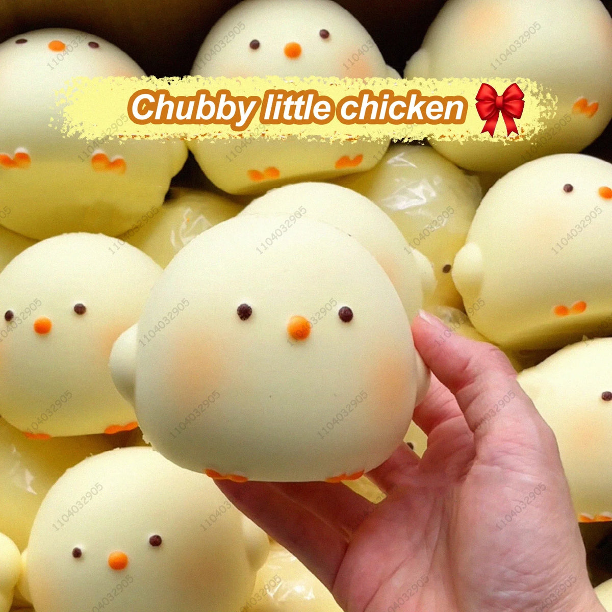 A hand holds a white chubby little chicken squishy toy surrounded by other similar toys.