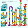 A colorful set of DIY marble run building blocks featuring a rotating disc, spiral staircase, and T-shaped bifurcation