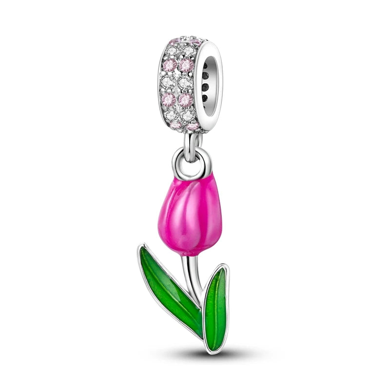 A silver heart charm bead featuring pink zircon stones and a pink tulip design.