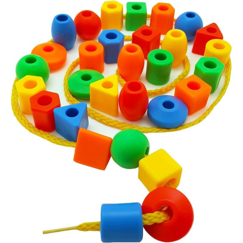 A colorful set of rainbow lacing beads and three strings used for a Montessori threading toy.