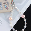 A silver necklace featuring pink and clear pearl crystals and star charms, displayed next to a phone case.