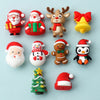 A collection of colorful silicone beads featuring Christmas characters like Santa, reindeer, and a penguin.