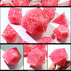 Pink resin D20 dice with floral designs shown from various angles and close-ups.