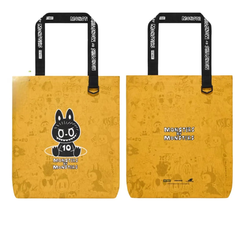 A pair of yellow paper shopping bags featuring a black illustration of a monster face and text.
