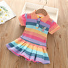 A colorful striped summer dress featuring rainbow hues and a rabbit embroidery, displayed on a wooden hanger.