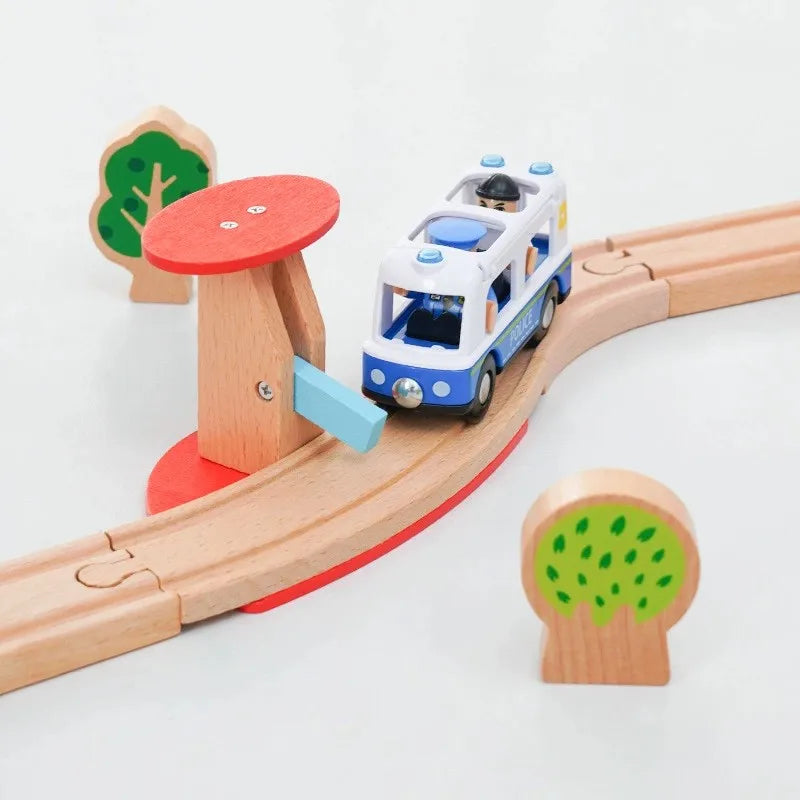 A wooden train track accessory set featuring a white and blue train on a curved track with wooden tree elements.