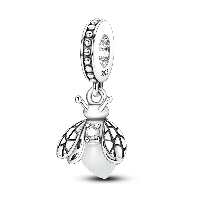 A sterling silver charm featuring a bee design with wings and a round bead.