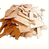 A pile of natural vegetable-tanned cowhide leather sheets for crafting in various shades of tan and brown.