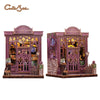 A detailed 3D wooden book nook kit featuring a purple and gold gothic library facade with intricate details.