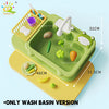 A green kids electric play sink with various food items and a faucet, shown on a yellow surface.
