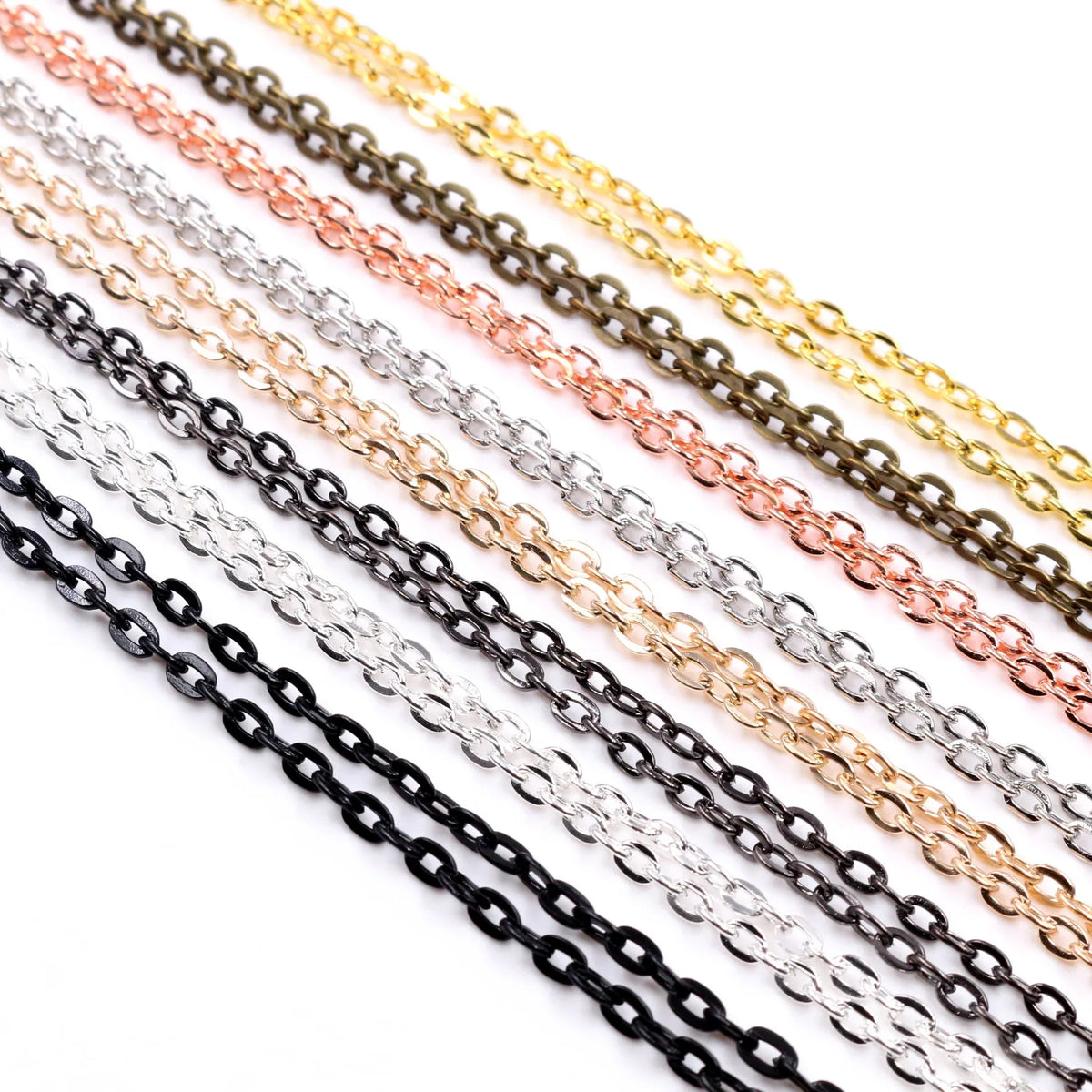 A collection of thin, flattened metal chain connectors in various colors including gold, silver, black, and rose gold.