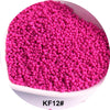 A pile of bright pink glass seed beads in a white bowl.