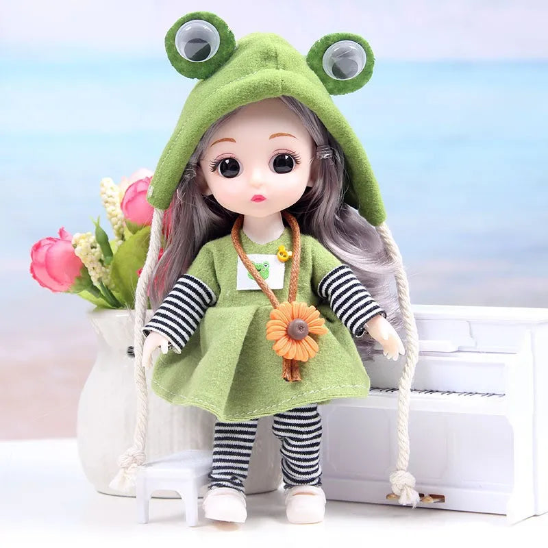 A 17cm articulated princess doll with a green hood and outfit sitting next to a white box.
