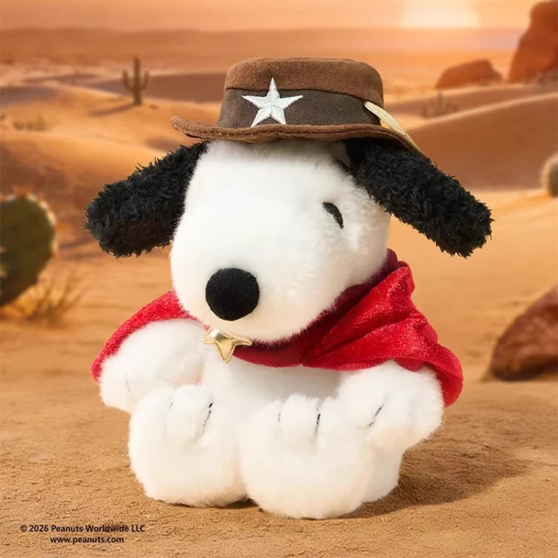 A white dog plush doll wearing a brown cowboy hat and a red bandana, set against a desert landscape.