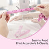Hands measure a person's body using a pink tape measure against a white cloth.