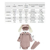 A set of pink rabbit romper, hat, and socks for babies, shown flat lay.