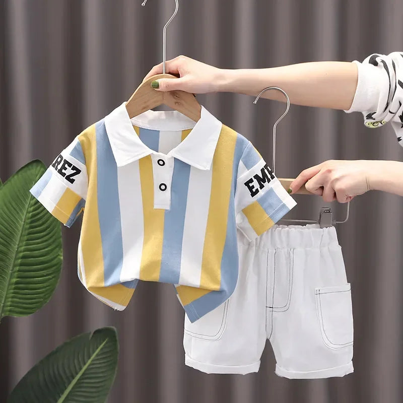 A boy's white and yellow striped short sleeve t-shirt and matching shorts set being displayed on a hanger.