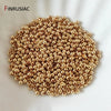 A pile of small gold-plated brass round spacer beads for jewelry making.