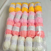A pack of 20 skeins of milk cotton blend yarn in various shades of pink and yellow for knitting and crochet.