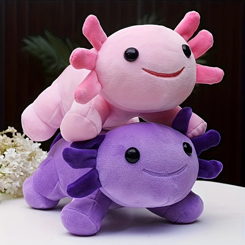 A pink axolotl plush toy is resting on a purple axolotl plush toy.