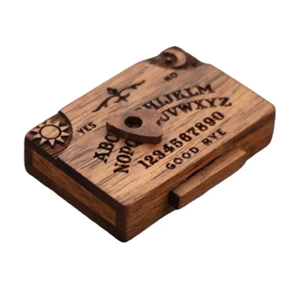 A wooden retro miniature Ouija board with a drawer featuring letters and numbers.
