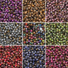 A collection of various golden gradient glass beads in multiple colors and shades for DIY jewelry making.