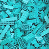 A pile of light blue and teal plastic building blocks scattered on a surface.