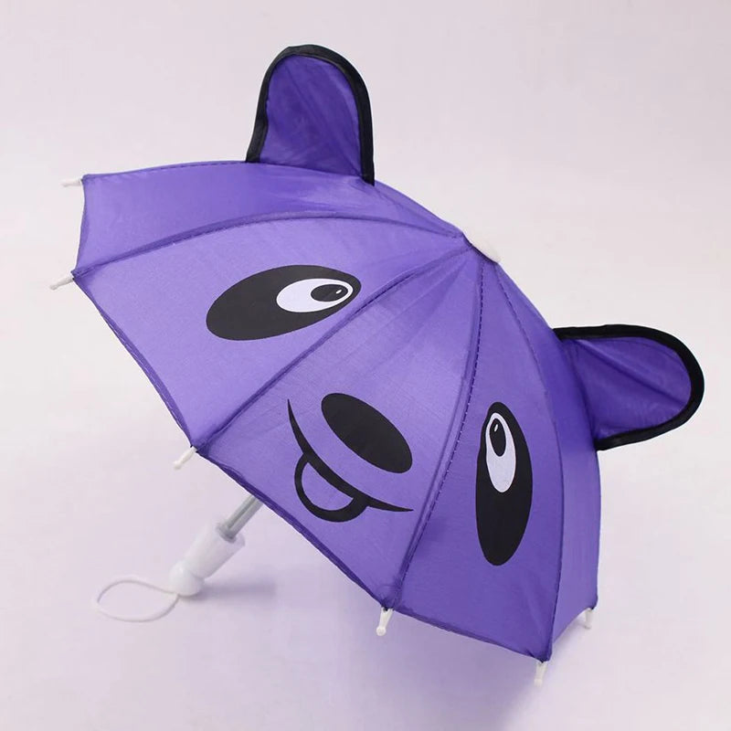 A purple lace-trimmed bear mini doll umbrella with black eyes and nose.