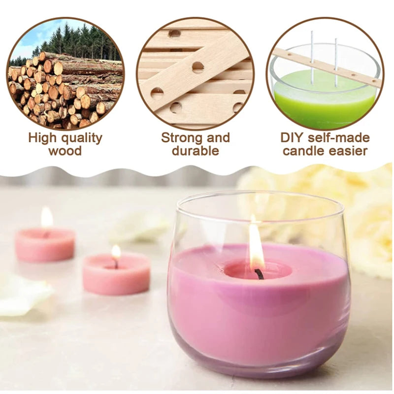A pink candle in a glass holder sits on a light surface with wood samples and candle components.