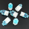 A set of seven floral resin potion bottles shaped like polyhedral dice, featuring various numbers and designs.